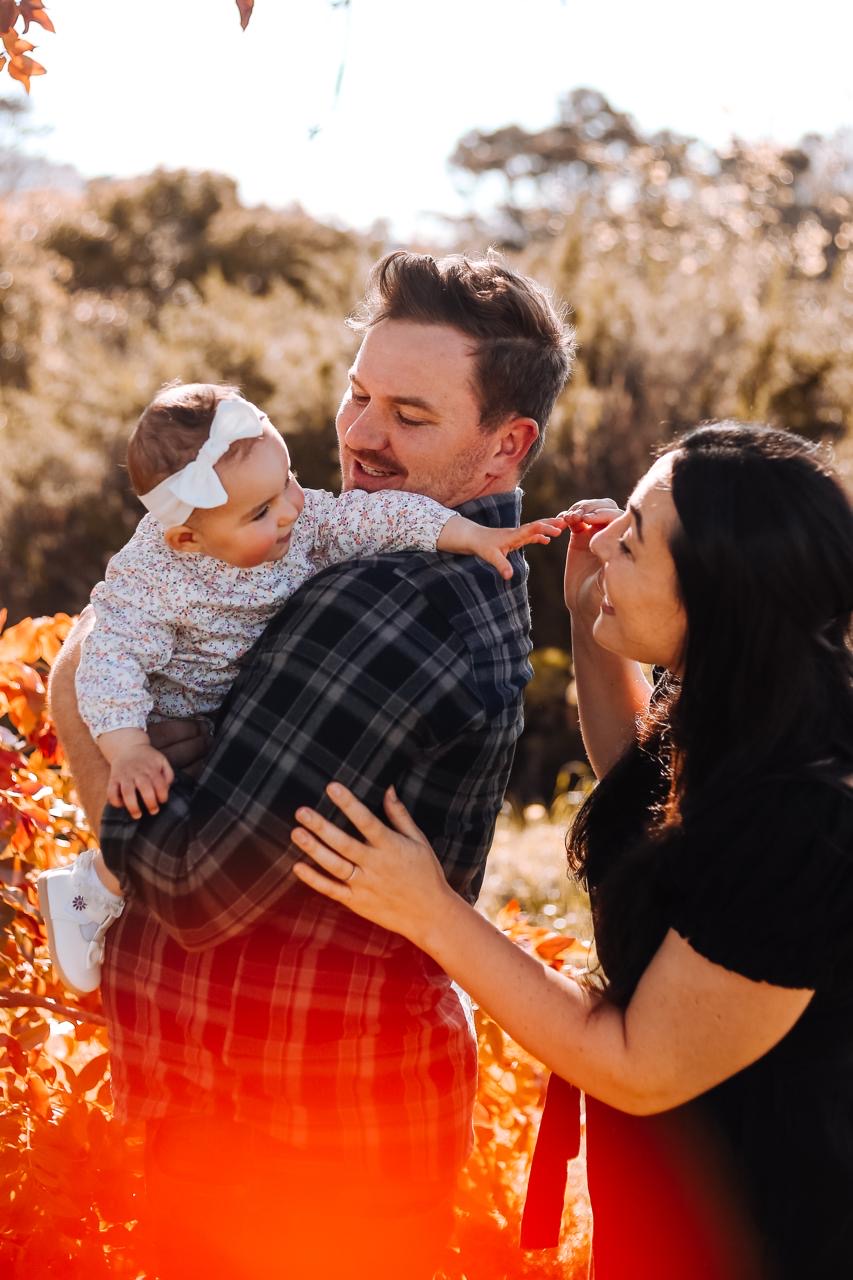 A family embracing in an autumn landscape