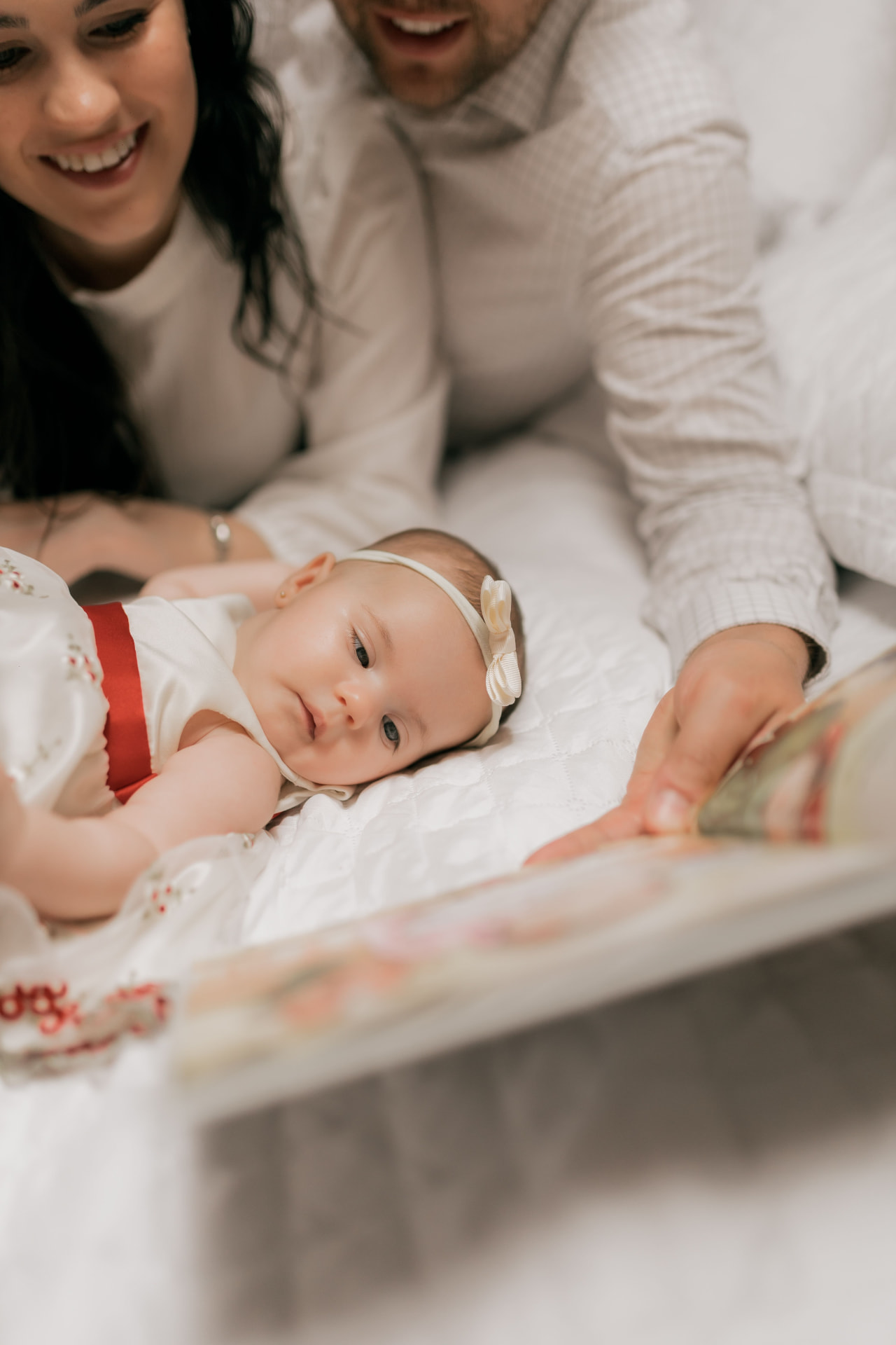 Parents reading a keepsake book with their baby