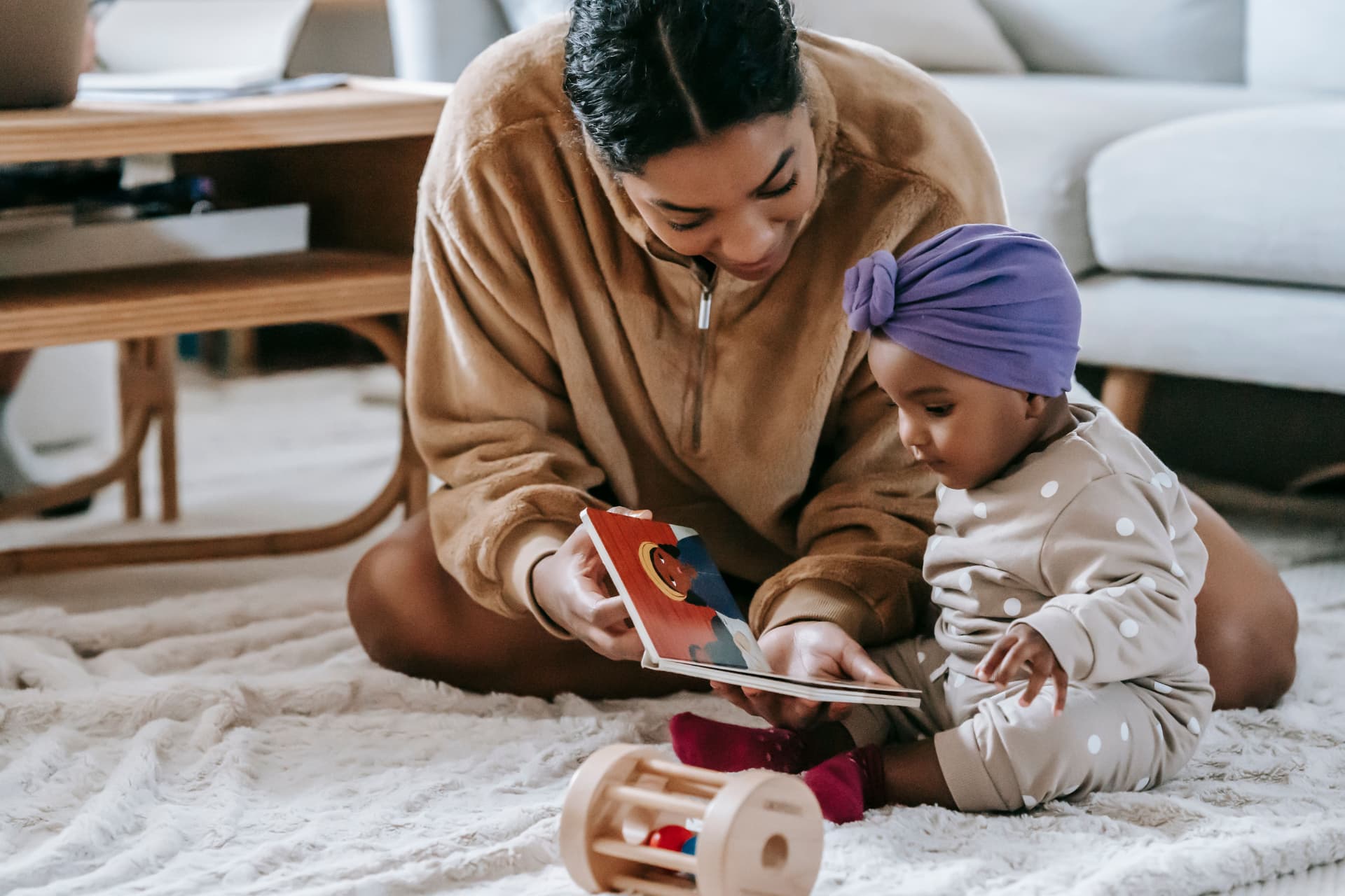 A mother reading a picture book with her baby