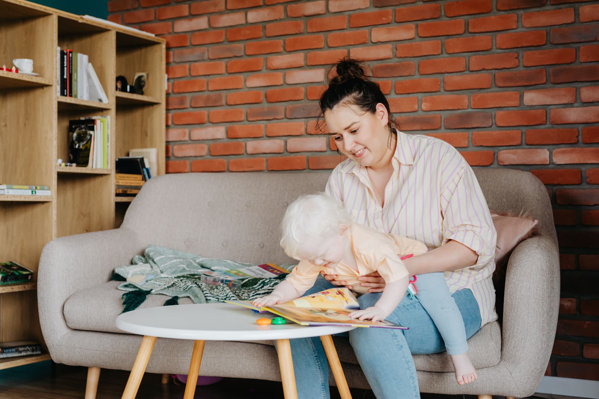 A mother and child sharing a picture book at home